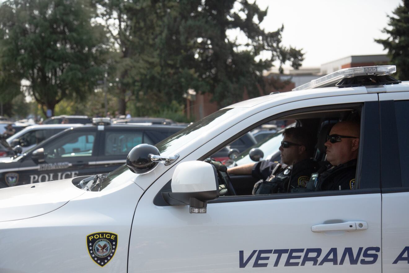 Officers John Bowers and Brett Roth, of the Veterans Affairs police, wait to participate in a procession honoring Clark County Sheriff's Office Detective Jeremy Brown on Aug. 3, 2021. Brown died July 23 while investigating a trio suspected in a firearms heist, records show.